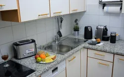 Bild 8: Funktionell eingerichtete Küche mit einer Arbeitsplatte aus Stein, Cerankochfeld, Spülmaschine. swissme holiday stmoritz